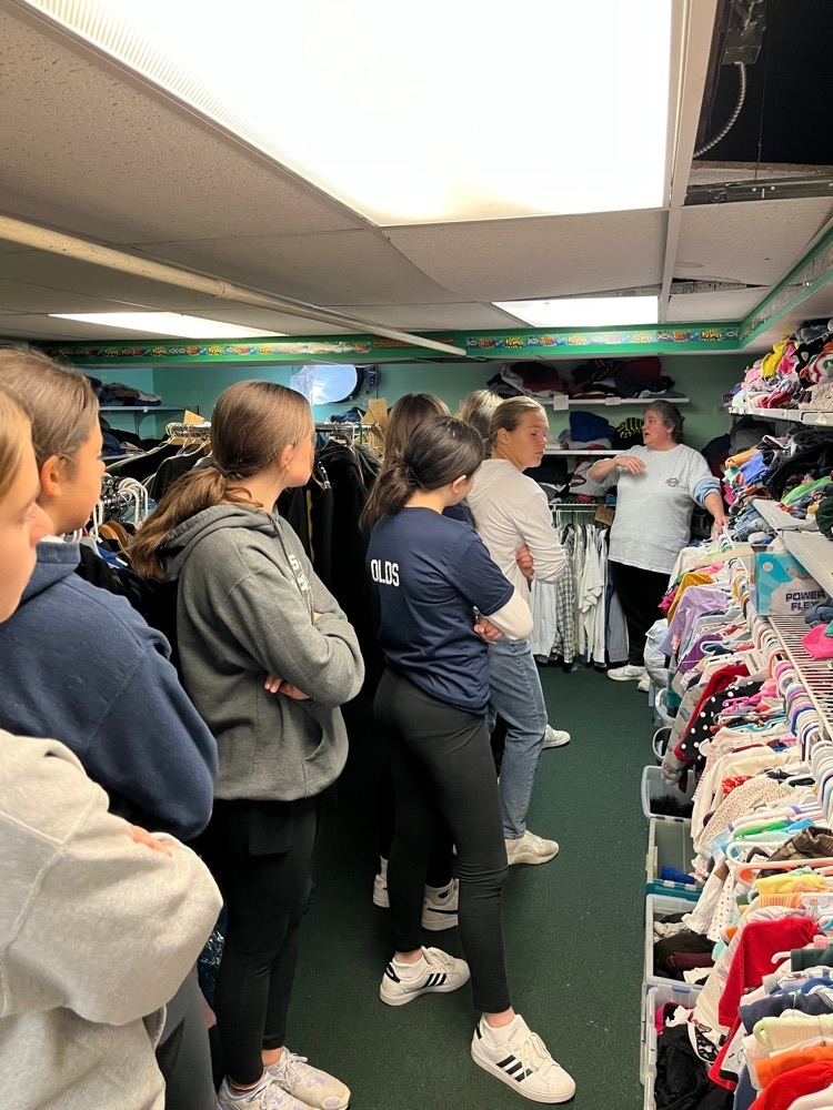 Learning about all the clothing and supplies available to the community 